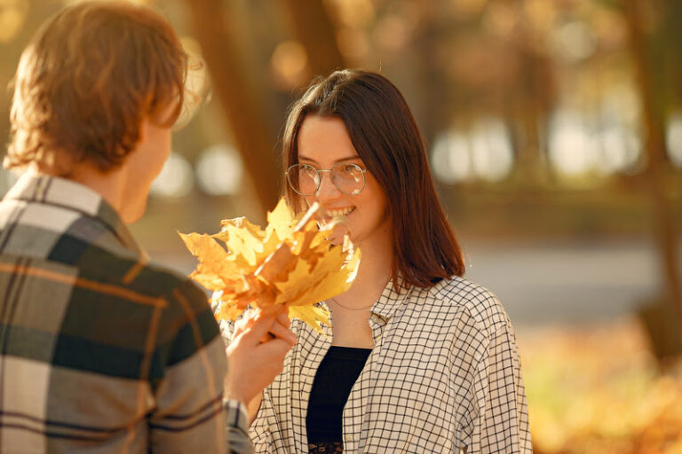 Couple in a park. Guy in a white t-shirt. Golden autumn